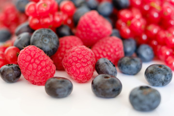 pile of fruits , blueberries and rasberries closeup