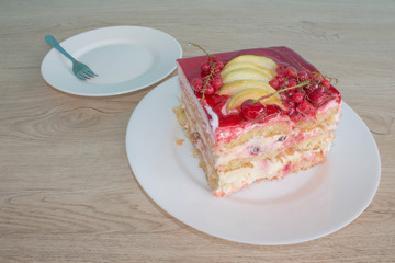 Cake with fresh red currant on the plate, closeup. Close up cake with red currant