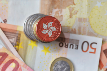 euro coin with national flag of hong kong on the euro money banknotes background.