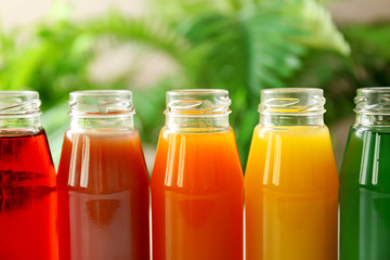 Delicious juices in bottles, closeup
