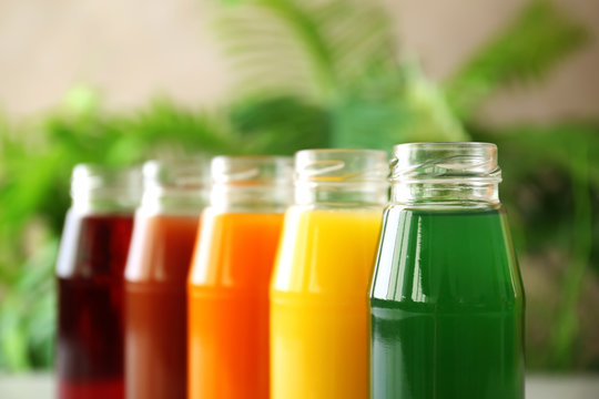 Delicious juices in bottles, closeup