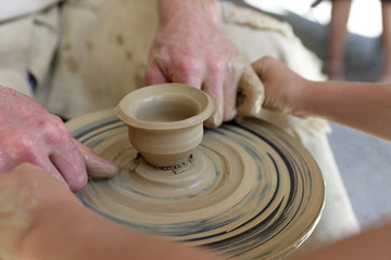 Fototapeta na wymiar Potter with boy making pottery