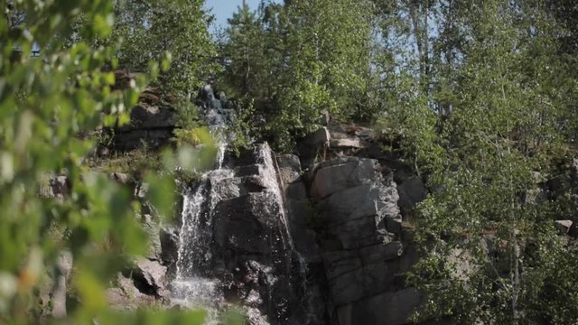Mountain waterfall. fast stream water summer landscape. Waterfall close up. Virgin waterfall spring