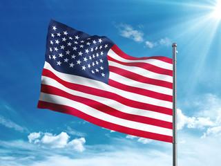 United states flag waving in the blue sky