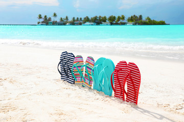 Colorful flip-flops on sea beach. Summer vacation concept