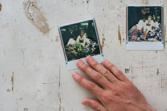 Male Hand Touching  Color Image on White Vintage Tabletop