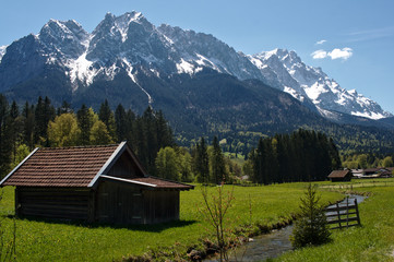 Obraz premium Alpine hut on a meadow with the Bavarian alps in the background, Garmisch-Partenkirchen, Bavaria, 2016 
