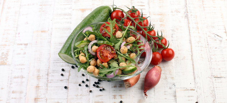Healthy homemade chickpea and veggies salad, arugula, diet, vegetarian, vegan food, vitamin snack