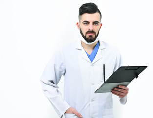 Doctor with beard holds clip folder for prescriptions.