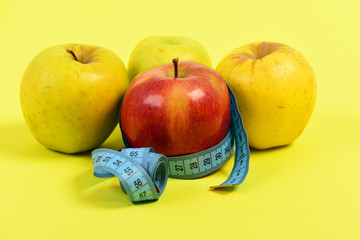 Measuring tape or flexible ruler in blue color and apples