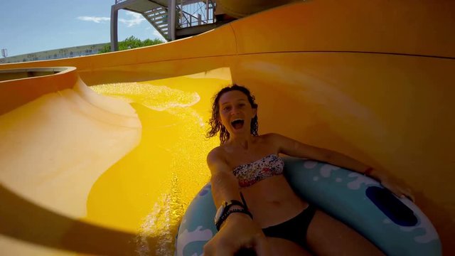 Girl goes down the waterslide tube at aqua 