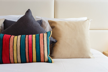 Colorful pillows on a bright bedroom