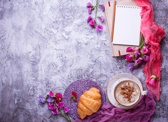 Fototapeta na wymiar Coffee, croissants, flower and notebook.