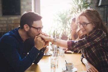 Happy couple flirting and dating in restaurant