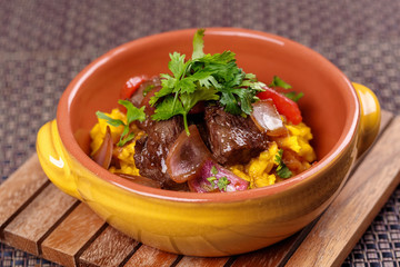 Grilled meat with raditional spanish rice decorated parsley