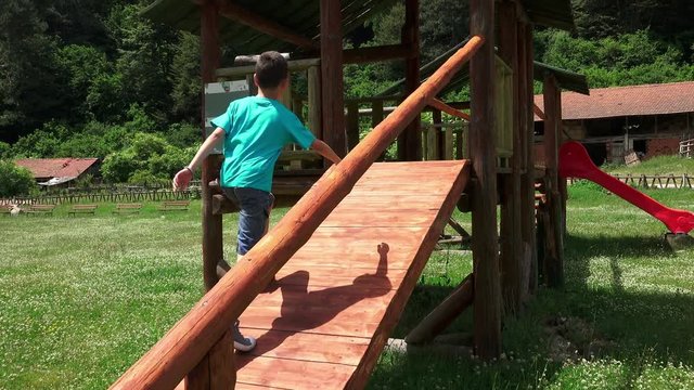 Excited boy in a Tree House Slideing