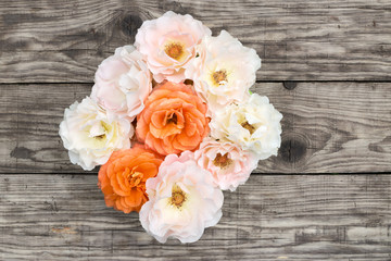 Pink and orange roses on old boards