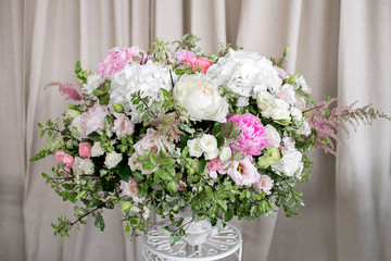 Arrange flowers in a white roman vase