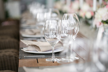 linen textile. Decorated table, a plate of neatly arranged napkin, fork and knife.