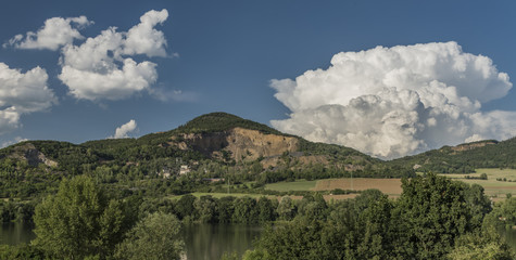 Obraz premium Quarry on hill near Libochovany village with big white clouds