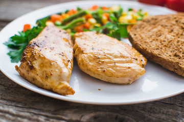 Breakfast on the wooden background from chicken breast