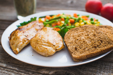 Breakfast on the wooden background from chicken breast