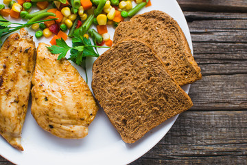 Breakfast on the wooden background from chicken breast