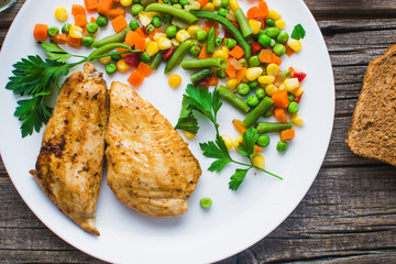 Breakfast on the wooden background from chicken breast