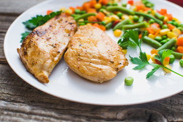 Breakfast on the wooden background from chicken breast