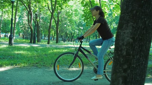 Girl on a bicycle in the park. Girl riding a bicycle.