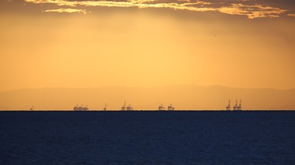 Naklejka na ściany i meble Sunset at the Port of Brisbane from North Stradbroke Island in Queensland Australia