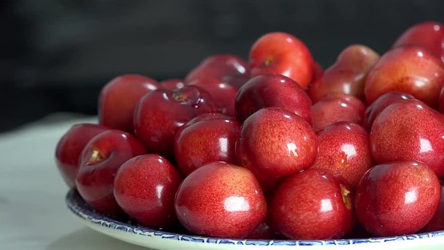 Red and fresh cherries pile food background rotating 