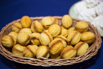 sweet buffet table. Beautifully decorated catering banquet table with burgers, profiteroles, salads and cold snacks. Variety of tasty delicious snacks on the table