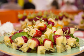 sweet buffet table. Beautifully decorated catering banquet table with burgers, profiteroles, salads and cold snacks. Variety of tasty delicious snacks on the table