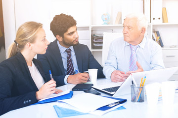 Employees are working together at computer