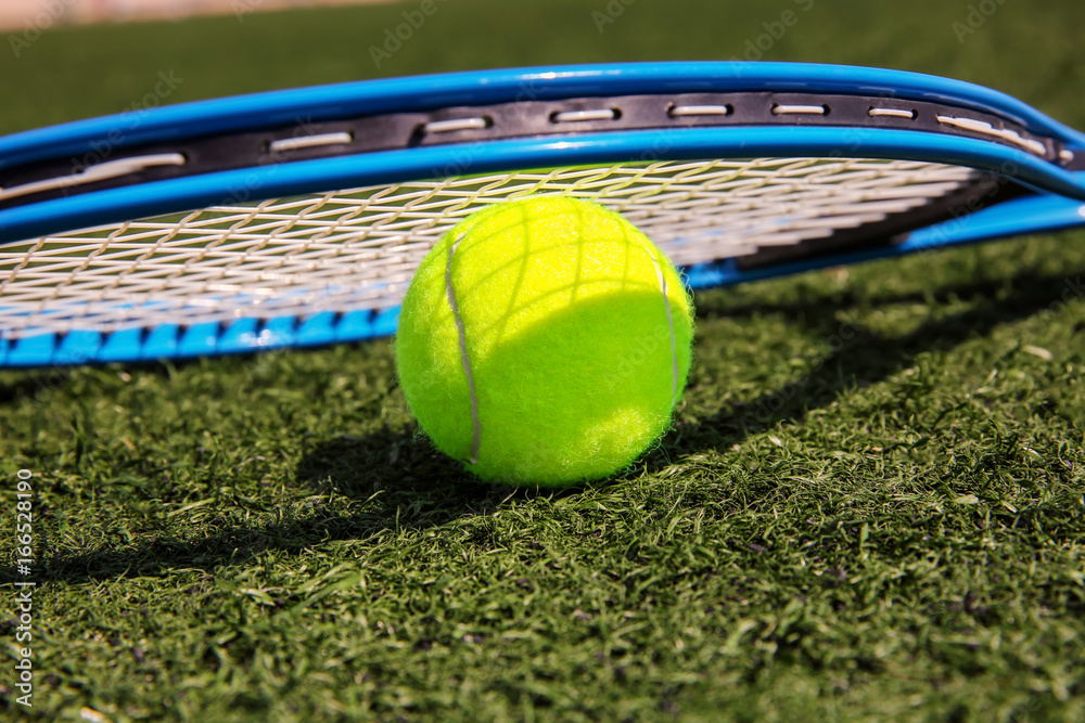 Canvas Prints Tennis ball and racket on fresh green grass outdoors