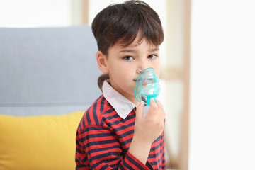 Boy using asthma machine at home