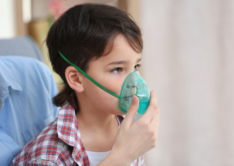 Boy using asthma machine at home