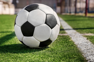 Fototapeta na wymiar Soccer ball on fresh green grass outdoors