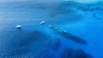 Boat over the shipwreck of the USS Kittiwake in Grand Cayman