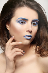 Beautiful young woman with creative make up, closeup