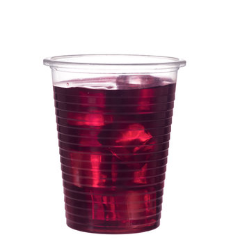 Red berry fruit drink in plastic cup, isolated on white. With ice.
