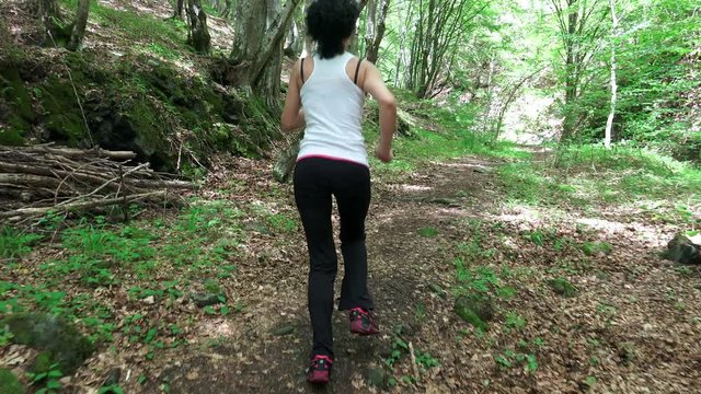 Runner athlete running on forest trail. woman fitness 