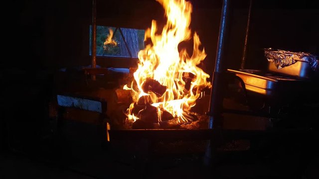 Burning fire at a fireplace inside a goahti, ready for dinner