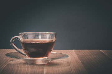 Hot tea cup on old wooden