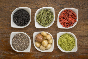 superfood set in small bowls against wood