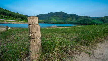 Rope Tied On Wooden Pole And Lake Mountain View