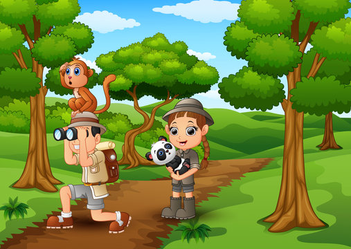 Zookeeper boy and girl with animals in the jungle