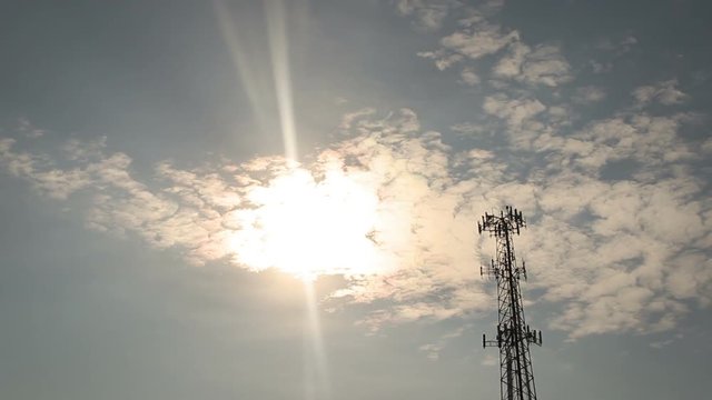Time lapse of Clouds evaporating in the sunlight near cellular tower