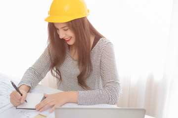 Architect or planner working on drawings for construction plans at a table
